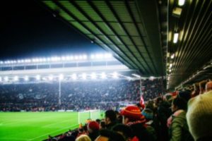 Blurred Liverpool Fans at Anfield During Evening Game