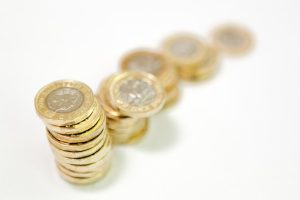 Blurred Increasing Pound Coin Stacks